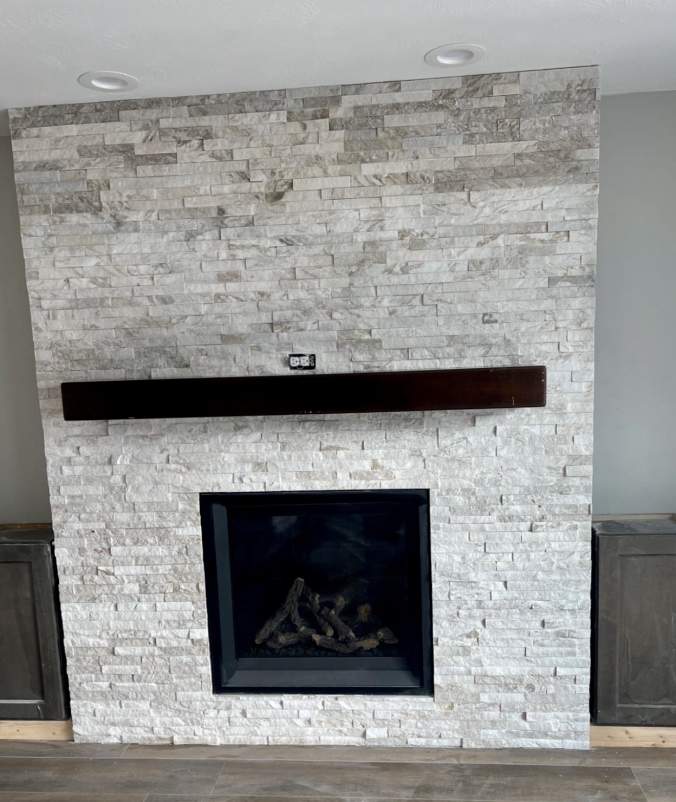 Floor-to-ceiling fireplace faced with textured stacked natural stone