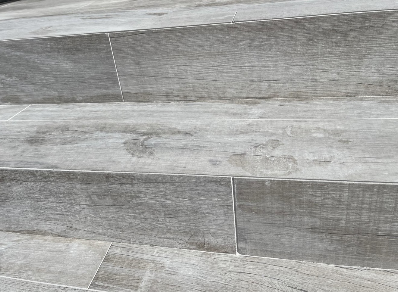 Detailed wood-look tile floor installation